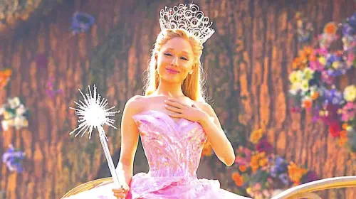 assets/ariana-grande-s-glinda-puts-a-hand-to-her-chest-in-wicked.jpeg