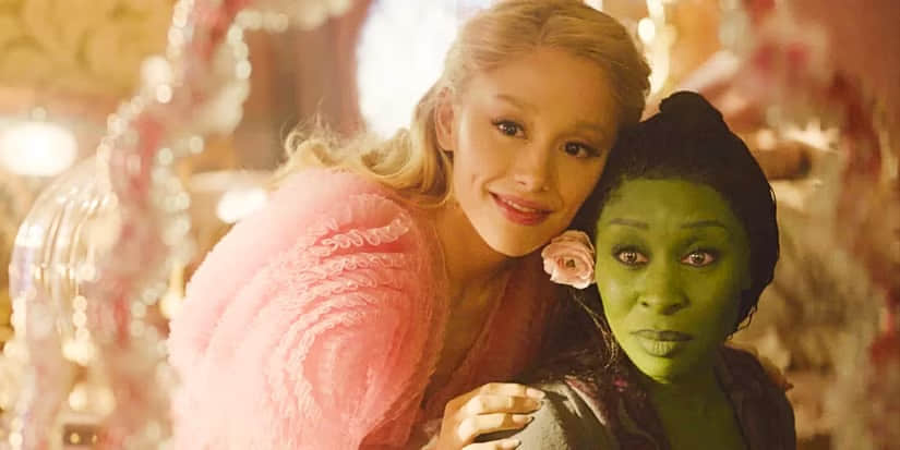 galinda-and-elphaba-looking-at-themselves-in-the-mirror-galinda-leaning-on-elphaba-in-wicked