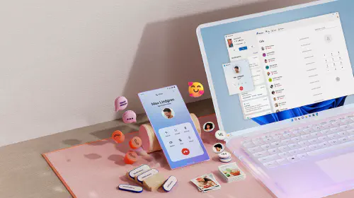 assets/msft-open-laptop-with-mobile-phone-floating-emojis-RW10WBx.jpeg
