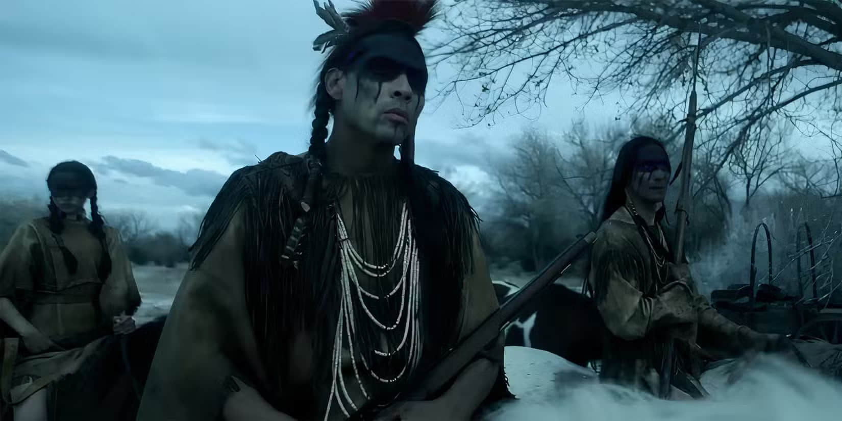 derek-hinkey-s-red-feather-looking-intensely-while-holding-a-rifle-in-american-primeval