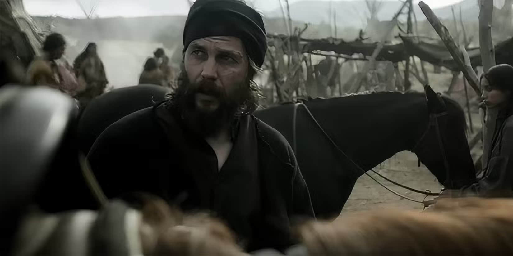 taylor-kitsch-s-isaac-looking-up-at-someone-on-a-horse-in-american-primeval