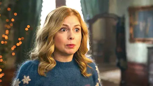 assets/rose-mciver-s-sam-looking-panicked-in-a-christmas-sweater-from-ghosts-season-4.jpeg