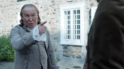 assets/neil-crone-as-ben-franklin-pointing-a-finger-at-higgintoot-in-ghosts-season-2.jpeg