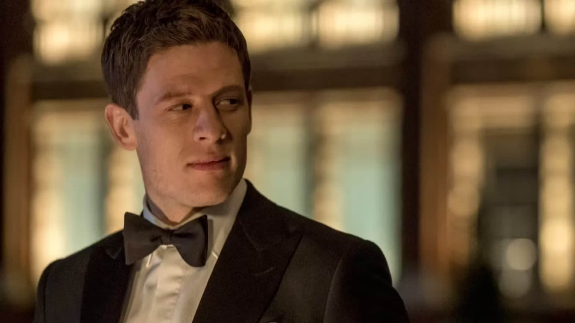 james-norton-as-alex-godman-wearing-a-tuxedo-and-bow-tie-looking-at-someone-off-screen-with-a-smirk-in-mcmafia-1
