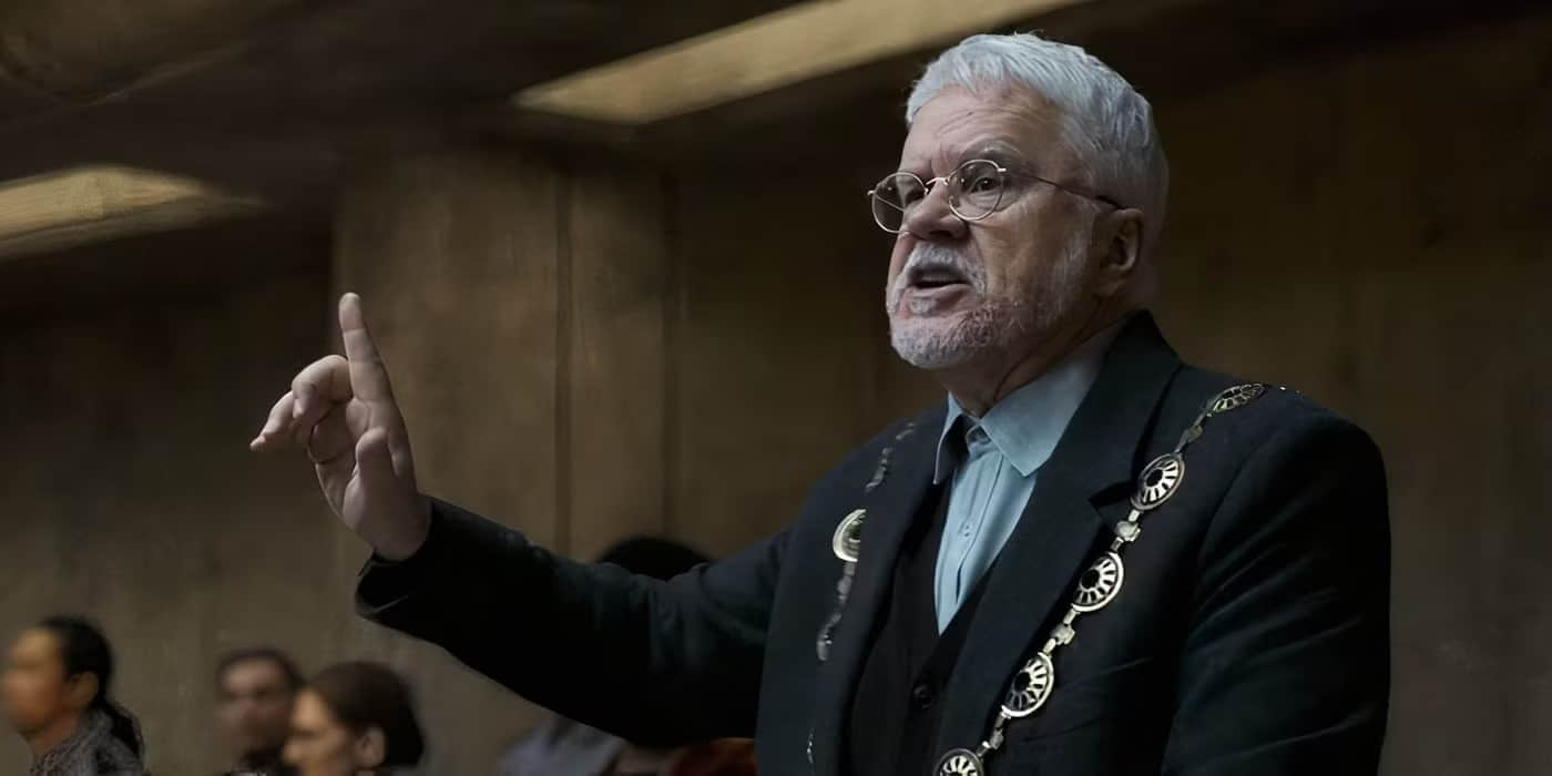 bernard-talks-to-a-crowd-of-people-inside-the-silo-in-silo-season-2
