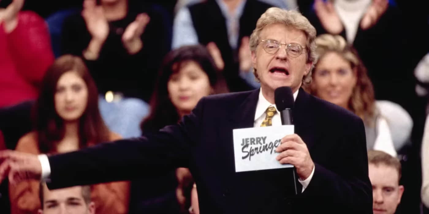 jerry-springer-pointing-off-camera-in-front-of-his-audience