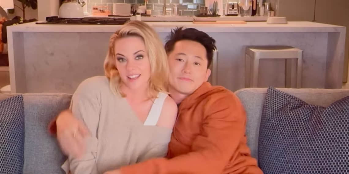 kristen-stewart-and-steven-yeun-sit-and-hug-on-a-couch-in-the-2025-movie-love-me