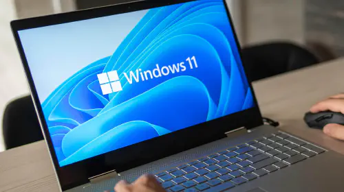 assets/Man-working-on-a-Windows-11-laptop-clearly-on-screen.jpeg
