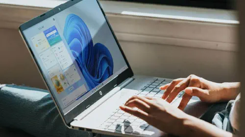 assets/Person-using-Windows-11-laptop-on-lap.jpeg