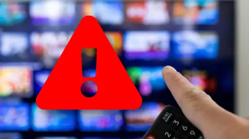 assets/Man-holding-remote-and-pointing-at-smart-TV-with-red-warning-icon.jpeg