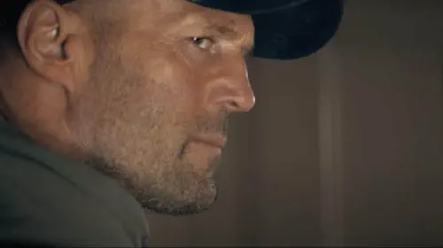 assets/statham-looks-to-side-a-working-man.jpeg