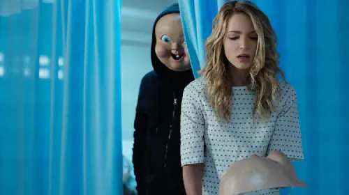 assets/baby-faced-killer-in-the-hospital-creeping-up-on-jessica-rothe-in-the-movie-happy-death-day-2u.jpeg
