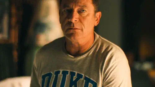 assets/jason-isaacs-in-the-white-lotus-wearing-a-duke-university-t-shirt.jpeg