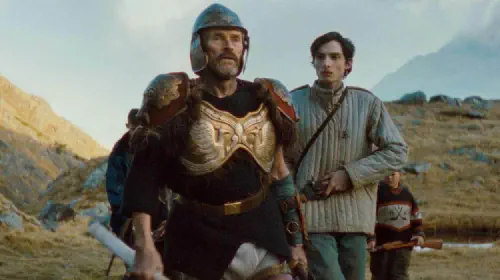 assets/willem-dafoe-in-armor-with-finn-wolfhard-in-the-movie-the-legend-of-ochi.jpeg