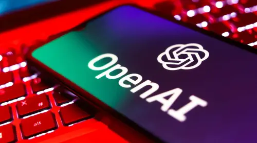 assets/OpenAI-logo-on-a-phone-screen-on-top-of-an-open-laptop-keyboard.jpeg