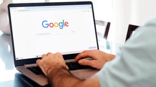 assets/Man-typing-on-laptop-with-Google-Chrome-on-screen-1.jpeg