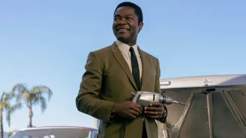 assets/daniel-oleyowo-with-a-powerdrill-in-the-tv-show-government-cheese-1.jpeg