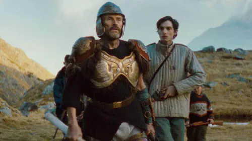 assets/willem-dafoe-in-armor-with-finn-wolfhard-in-the-movie-the-legend-of-ochi.jpeg