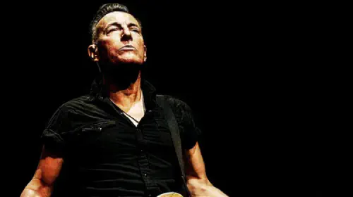 assets/bruce-springsteen-performing-on-stage-in-road-diary.jpeg