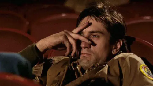 assets/robert-deniro-as-travis-bickle-with-fingers-over-his-eyes-in-a-scene-from-taxi-driver.jpeg