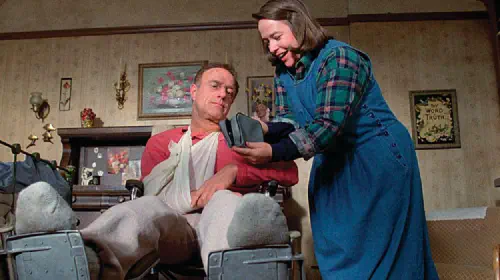assets/annie-wilkes-shows-a-small-bag-to-paul-sheldon-in-misery.jpeg