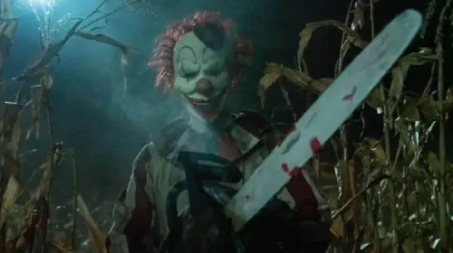 assets/a-clown-holds-a-chainsaw-in-the-film-clown-in-a-cornfield.jpeg