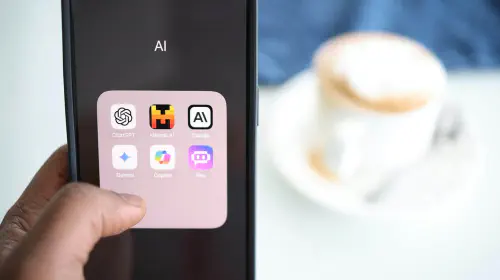 assets/Man-holding-phone-with-collection-of-AI-apps-on-screen.jpeg
