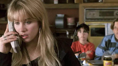 assets/christina-applegate-speaks-on-the-phone-in-don-t-tell-mom-the-babysitter-s-dead.jpeg