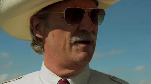 assets/close-up-of-jeff-bridges-in-a-cowboy-hat-and-sunglasses-in-the-movie-hell-or-high-water.jpeg