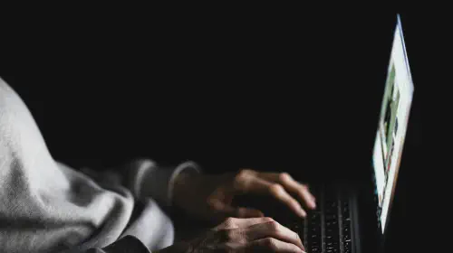 assets/Anonymous-woman-using-laptop-in-darkness.jpeg