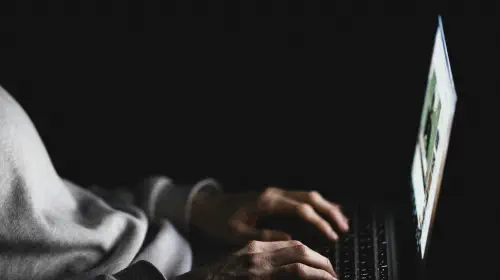 assets/Anonymous-woman-using-laptop-in-darkness.jpeg