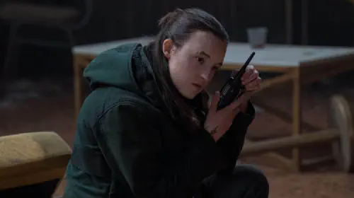 assets/bella-ramsey-as-ellie-listening-to-a-radio-in-the-last-of-us.jpeg