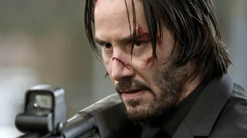 assets/keanu-reeves-holding-shotgun-in-john-wick.jpeg