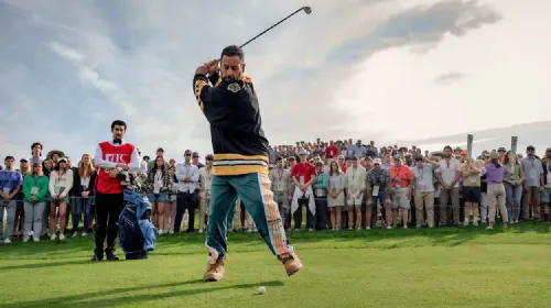 assets/happy-on-the-golf-course-swinging-in-a-boston-bruins-jersey-in-happy-gilmore-2.jpeg