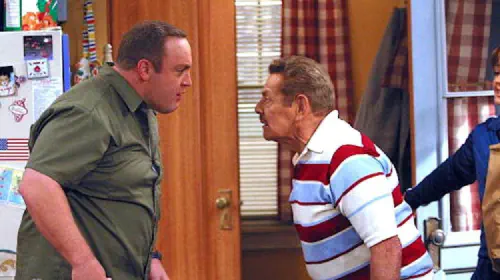 assets/kevin-james-stands-agains-jerry-stiller-in-the-king-of-queens.jpeg