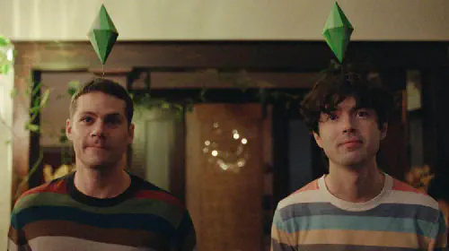 assets/dylan-o-brien-and-james-sweeney-with-game-jems-above-their-heads-in-the-2025-sundance-movie-twinless.jpeg