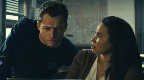 assets/taron-egerton-and-jurnee-smollett-in-office-in-smoke.jpeg