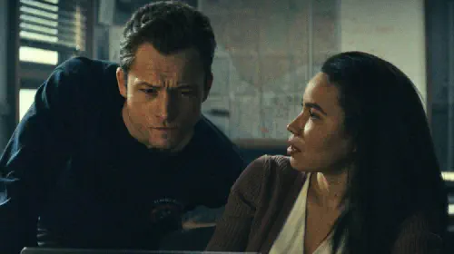 assets/taron-egerton-and-jurnee-smollett-in-office-in-smoke.jpeg
