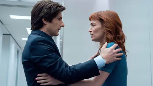 assets/mark-and-helly-facing-one-another-her-arms-on-her-torso-and-his-on-her-shoulders-in-severance.jpeg