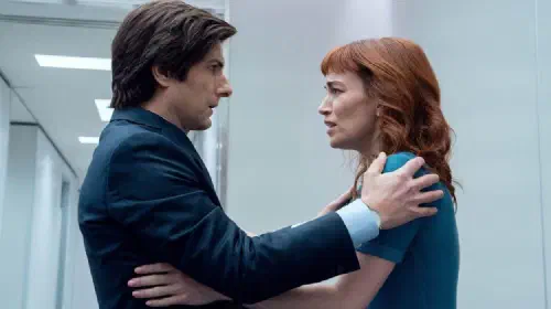 assets/mark-and-helly-facing-one-another-her-arms-on-her-torso-and-his-on-her-shoulders-in-severance.jpeg
