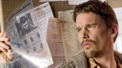 assets/ethan-hawke-looks-at-evidence-in-the-film-sinister.jpeg