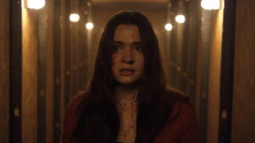 assets/a-girl-looking-scared-in-the-film-haunt.jpeg