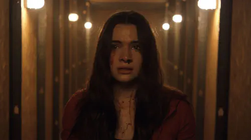 assets/a-girl-looking-scared-in-the-film-haunt.jpeg