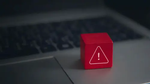 assets/Red-warning-cube-on-a-laptop-keyboard-in-darkened-room.jpeg