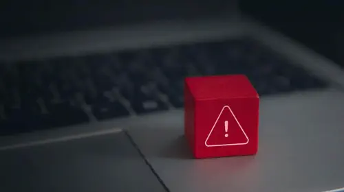 assets/Red-warning-cube-on-a-laptop-keyboard-in-darkened-room.jpeg