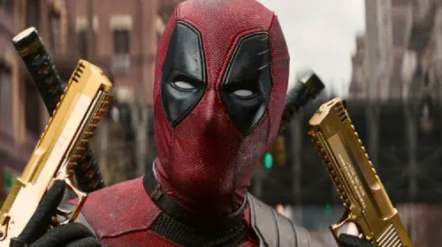 assets/ryan-reynolds-with-gold-pistols-in-deadpool-wolverine.jpeg