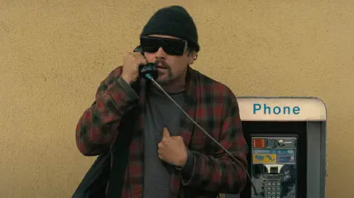 assets/leonardo-dicaprio-talking-on-a-public-phone-in-one-battle-after-another.jpeg