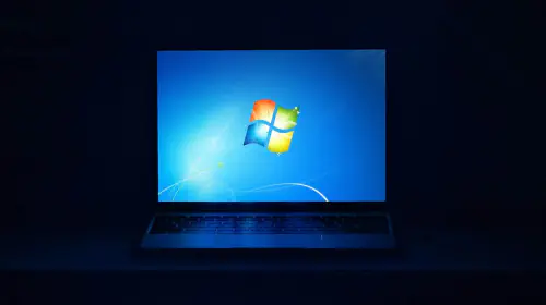 assets/Windows-7-on-laptop-screen-in-dark-room.jpeg