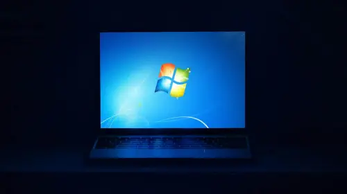 assets/Windows-7-on-laptop-screen-in-dark-room.jpeg