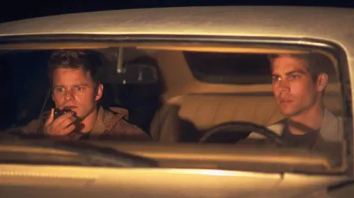 assets/lewis-and-fuller-in-a-car-in-joy-ride.jpeg